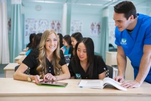 Three massage therapy students at MaKami College on their way to becoming massage therapists in Alberta