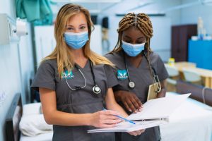 two female medical office assistant students at MaKami College in a clinical setting