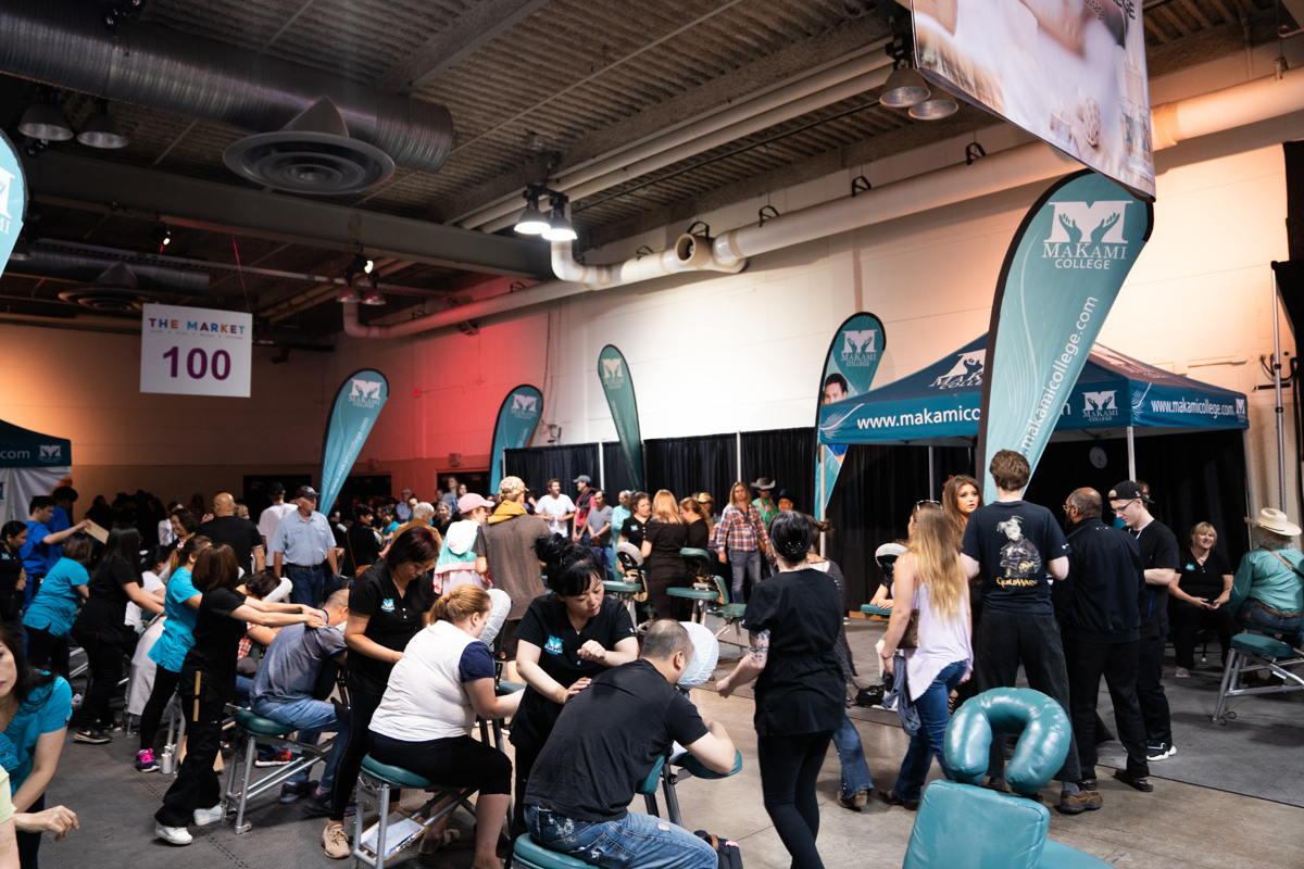 MaKami College massage therapy students provide seated massages inside teh BMO Centre during the Calgary Stampede in 2019