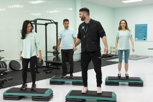 personal fitness trainer teaching students in a fitness class