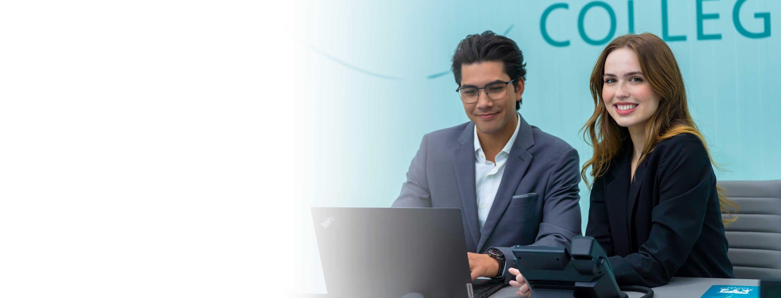 a male and a female Applied Politics and Public Affairs  student on a laptop at MaKami College