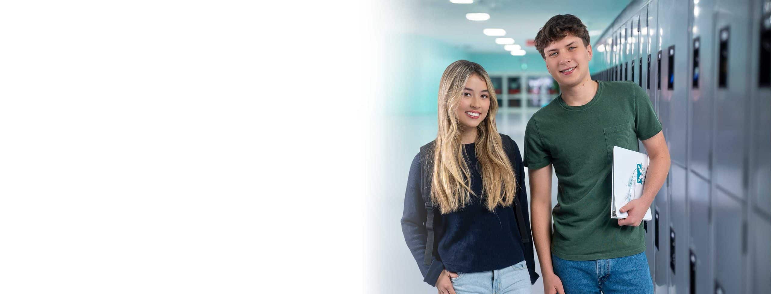 a male and female student at MaKami College in Alberta Canada holding a class binder
