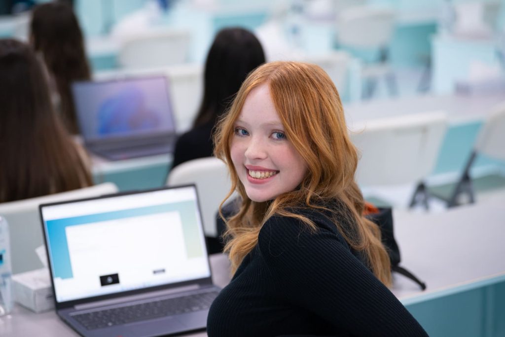 Digital marketing diploma student reviewing social media analytics on a laptop