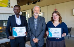Olivier Hitimana and Brianna Milgaard hold Richard R. Singleton Award certificates with donor Richard Singleton at MaKami College.