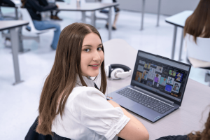 : Student planning a social media campaign on a laptop at MaKami College